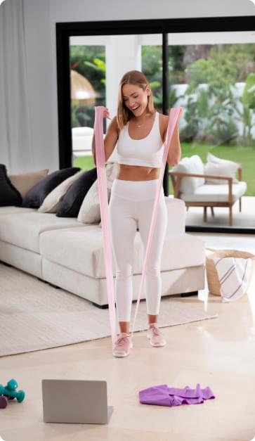 Full shot of woman exercising with elastic band.